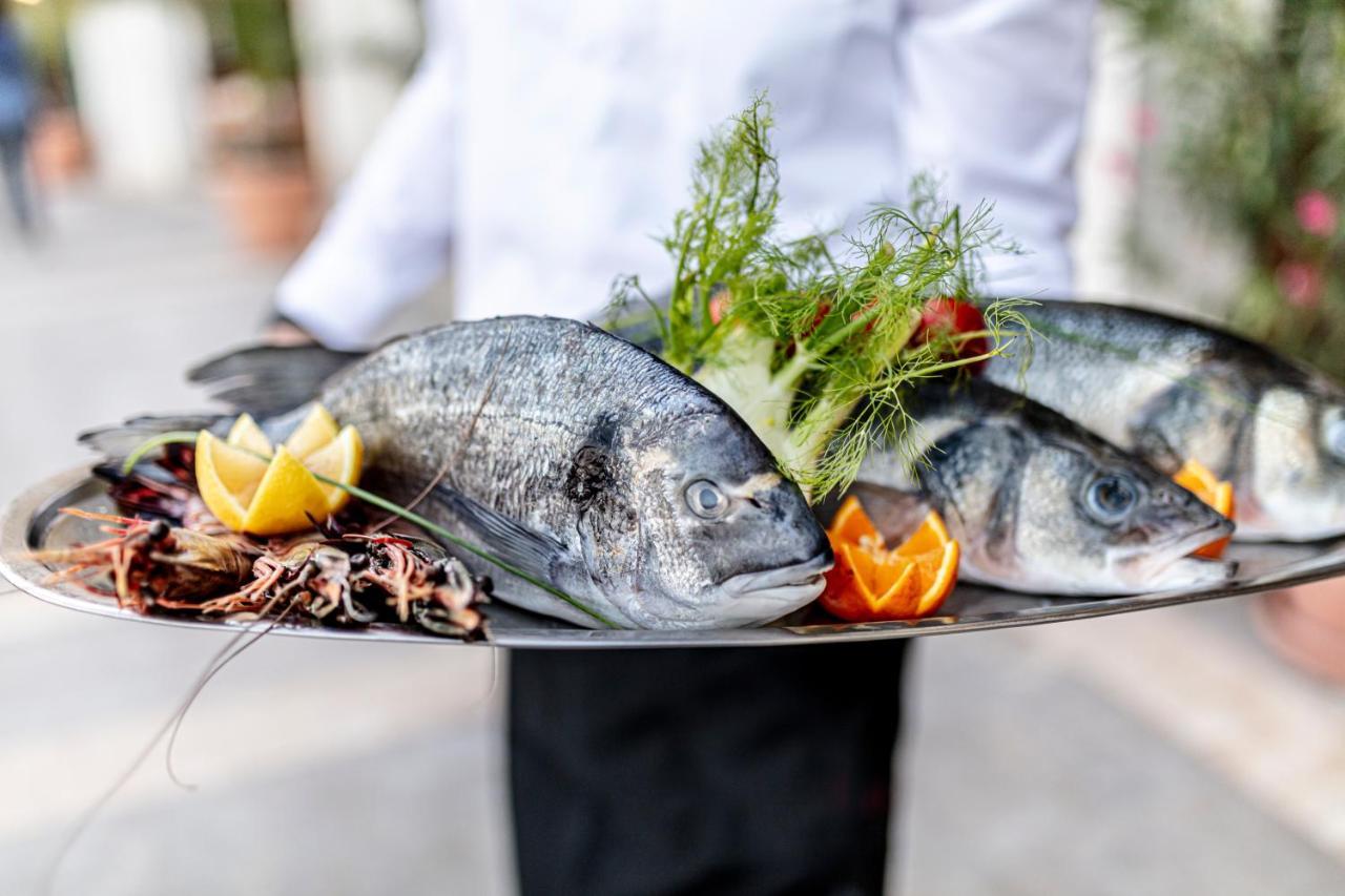 Lighthouse Golf & Spa Hotel บัลชิค ภายนอก รูปภาพ A waiter holding a platter of fish